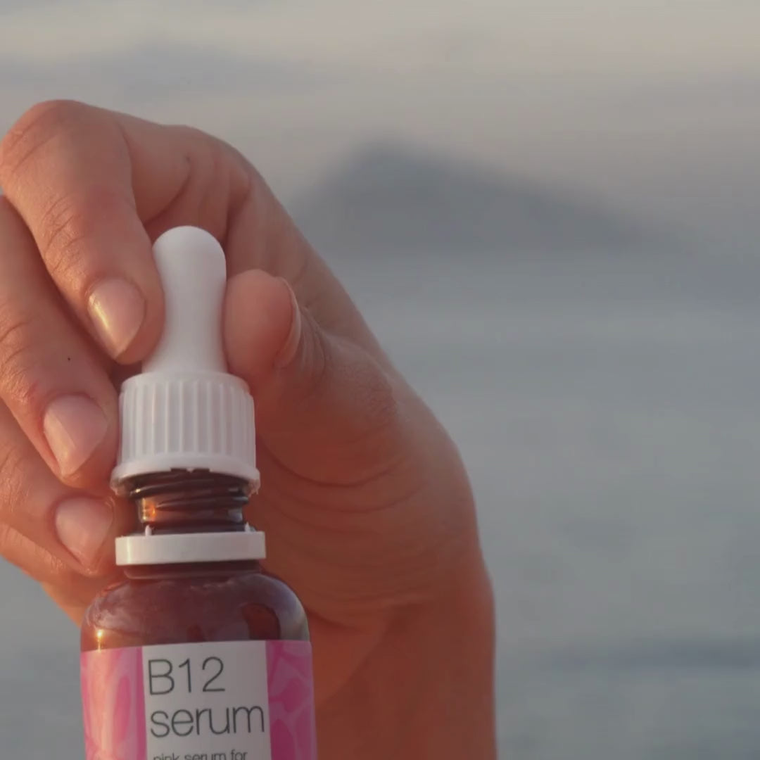 Video of a model applying our Vitamin B12 Pink Serum to her face, gently massaging it in to show its lightweight texture and radiant finish.