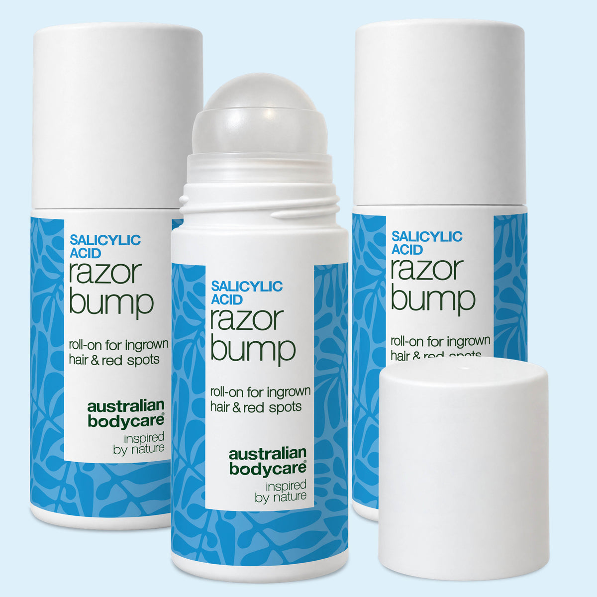 Three Salicylic Acid Razor Bump roll-ons from Australian Bodycare on a white background, the front one with its cap off beside it. 3-pack.
