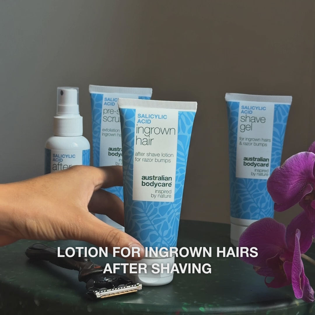 Video: After Shave spray, Pre-shave Scrub, Ingrown Hair lotion and Shave Gel on a table beside a razor and an orchid, with the text “lotion for ingrown hairs after shaving”. Salicylic Acid Aftershave Lotion from Australian Bodycare.