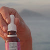 Video of a model applying our Vitamin B12 Pink Serum to her face, gently massaging it in to show its lightweight texture and radiant finish.
